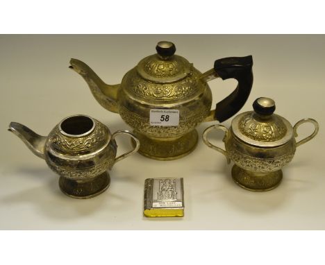 A silver coloured metal teapot, another smaller; a sucrier; a silver coloured metal snuff box as a book (4)