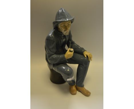 A Nao model of an elderly Fisherman smoking a pipe, in glazed tones (faults)