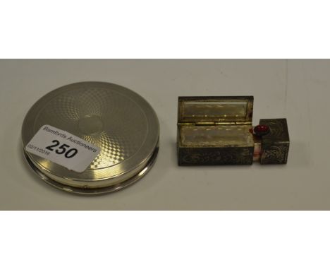 A silver compact, engine turned, London 1947; a silver coloured lipstick holder (2)