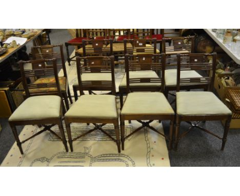 A set of eight Victorian mahogany dining chairs, stylised ladder back to splat, fluted to frieze, turned legs, X-frame stretc