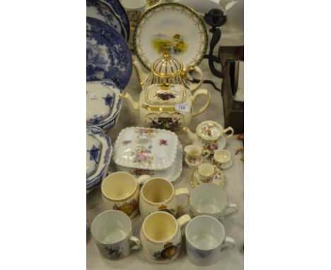 A Royal Worcester plate, painted with meandering stream, swag and husk tendril border, printed crown and circle mark, date co