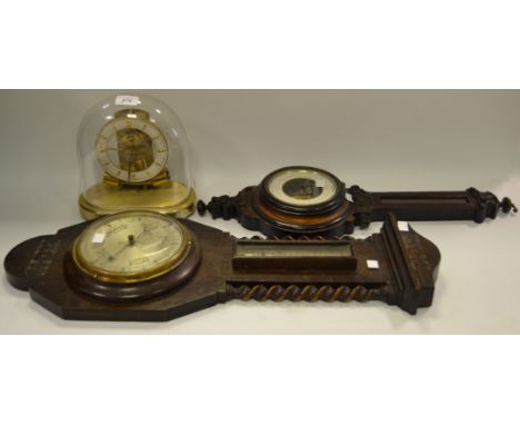 A brass carriage clock, glass dome; an oak banjo barometer, barley twist supports; another smaller (3)