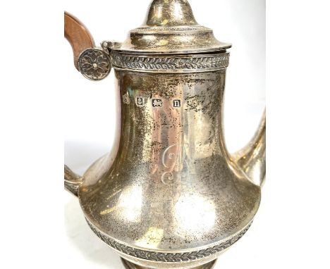 A four piece hallmarked silver Georgian style tea service decorated with floral and leaf bands, pineapple finials, one pot wi