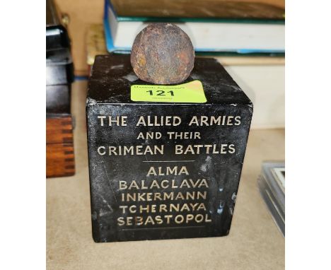 A marble cube commemorating the Allied Armies Crimean Battles surmounted by small cannon ball and the back of a Russian Offic
