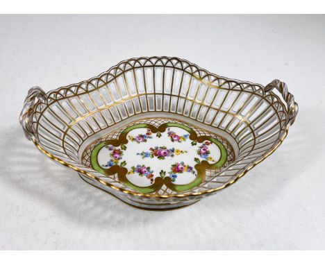 A Dresden oval shaped open work basket with twin handles and gilt and polychrome decoration