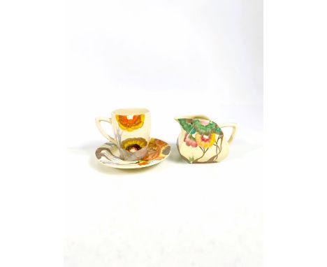 A Clarice Cliff coffee cup and saucer Rhodanthe pattern, printed mark for Wilkinson Ltd.; a Viscaria cream jug, black printed