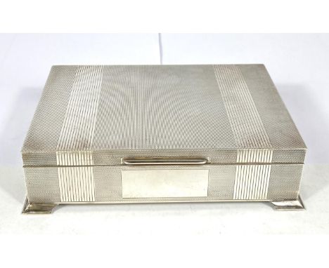 A hallmarked silver cigarette box, engine turned, on bracket feet, Birmingham 1961 