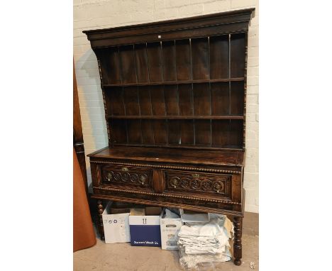 A late 19th/early 20th century Welsh dresser in the Georgian style with 2 height delft rack over 2 drawers, with carved and b