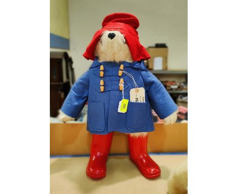 A Paddington Bear with royal blue duffle coat, red hat and red wellies, with luggage tag attached, design registration 957892