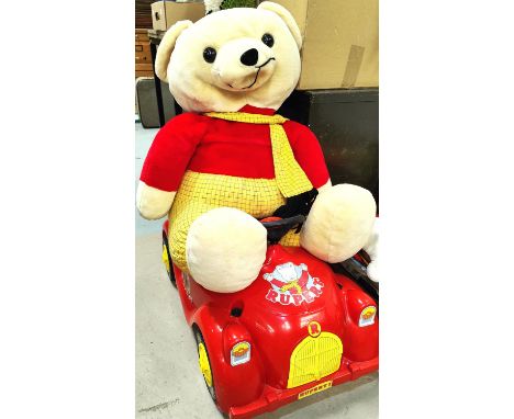 A very large Rupert Bear plush teddy bear, a peddle car and a rocking Rupert 