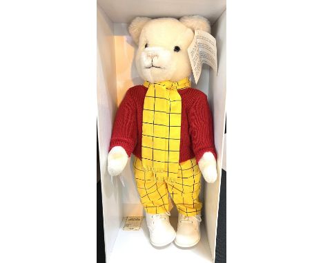 A Merrythought Rupert Bear with original tag and box, red jumper, yellow &amp; black trousers &amp; scarf, white lace-up shoe