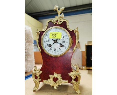 A 19th century Louis XV style mantel clock in tortoiseshell effect case&nbsp;with extensive ormolu mounts and feet, white ena