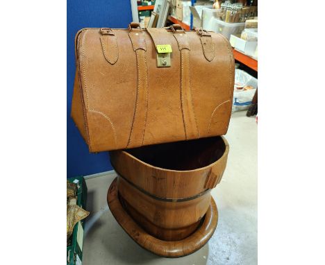 A tan leather Gladstone type bag; a wooden bucket and trough.