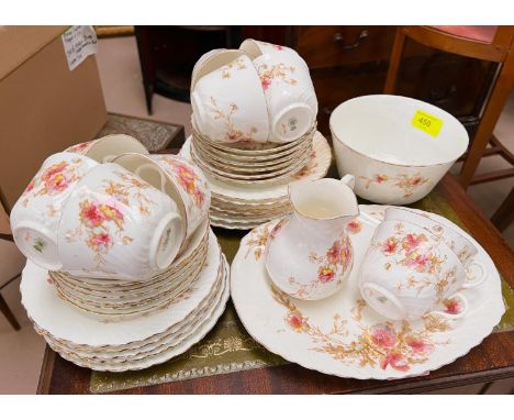 A Victorian tea service by Doulton Burslem with gilt rims and floral decoration on white ground 