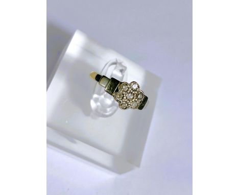 A yellow metal dress ring stamped '18ct plat' set 7 diamonds as a flowerhead, 2.8gm, size K 