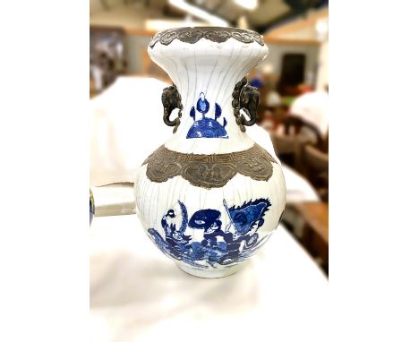 A Chinese porcelain baluster shaped vase decorated in under glaze blue with battle scene, bronzed effect frieze and handles, 
