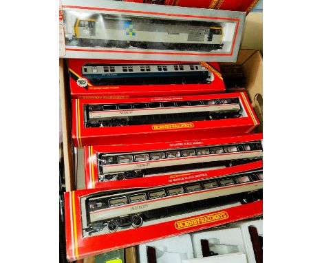 A boxed Lima Locomotive Class 60; five boxed Hornby coaches and three unboxed. 