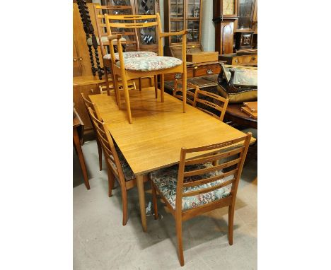 A 1970's G Plan style teak dining suite, comprising of a rectangular extendable table and 6 pierced ladder back chairs. 