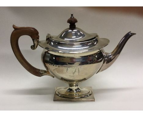 An Edwardian silver teapot on pedestal base. Birmingham. By H&amp;M. Approx. 360 grams. Est. £100 - £200.