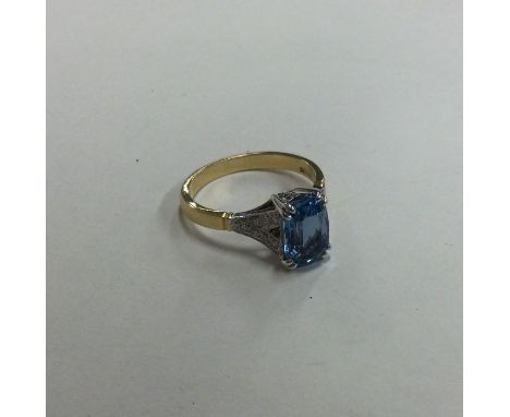 A good aquamarine and diamond crossover ring of stylised form in double claw mount. Approx. 4 grams. Est. £600 - £800.