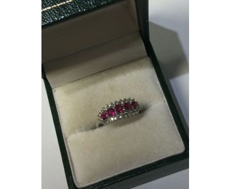 A ruby and diamond three row ring in 18 carat gold. Approx. 3 grams. Est. £80 - £120.