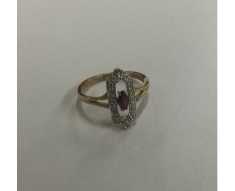 An attractive ruby and diamond cocktail ring of stylised form. Approx. 2 grams. Est. £80 - £120.