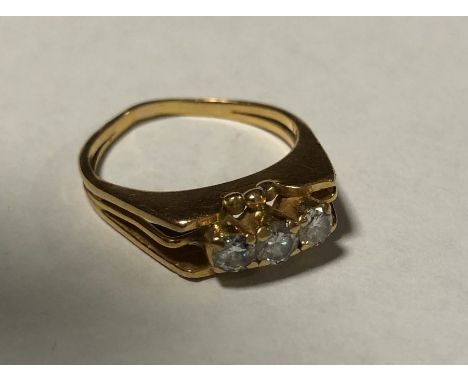 An 18 carat gold and diamond three stone ring. Approx. 7 grams. Est. £100 - £150.