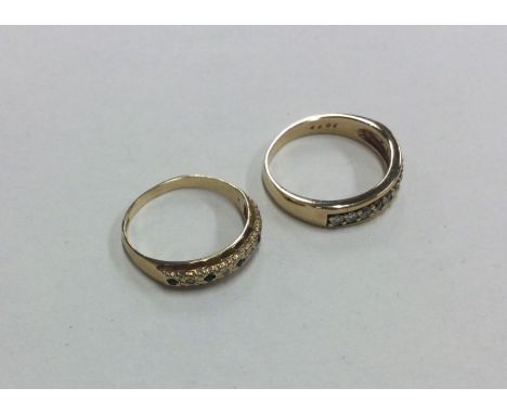 A diamond mounted half eternity ring together with one other. Approx. 5 grams. Est. £50 - £80.