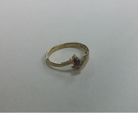 A ruby and diamond four stone crossover ring. Approx. 2 grams. Est. £40 - £60.