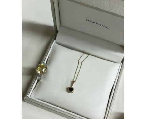 A heavy sapphire mounted pendant on gold chain together with a dress ring. Est. £20 - £30.