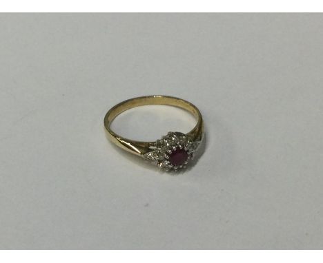 A 9 carat ruby and diamond daisy head cluster ring. Approx. 2 grams. Est. £50 - £80.