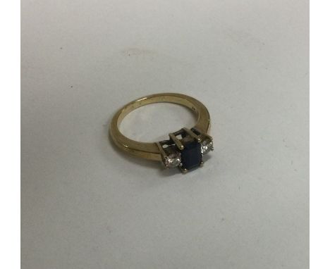 A 9 carat gold mounted sapphire and diamond three stone ring. Approx. 3 grams. Est. £80 - £120.