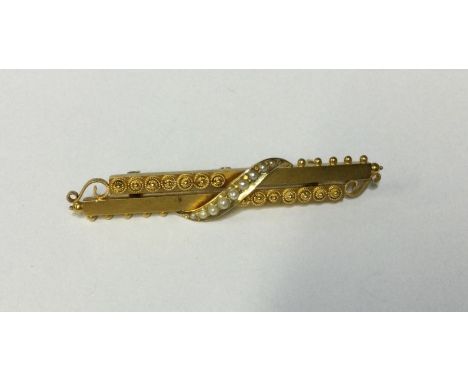 A 15 carat rectangular gold brooch with pearl decoration. Approx. 3 grams. Est. £70 - £80.
