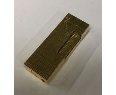 A Dunhill gold plated lighter. Est. £20 - £30.