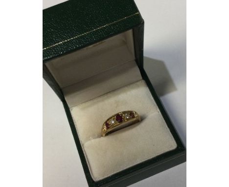 An 9 carat ruby and diamond five stone ring. Approx. 3 grams. Est. £70 - £80.