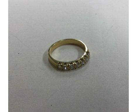 A good quality eight stone diamond half eternity ring in 18 carat gold claw mount. Approx. 4 grams. Est. £400 - £500.