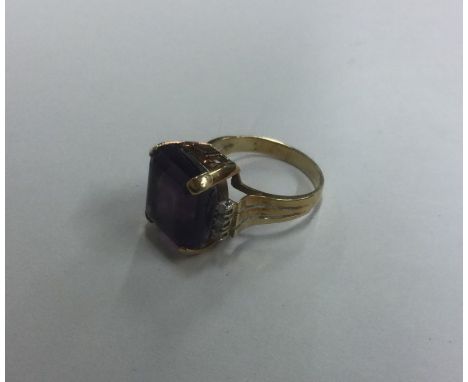 A stylish amethyst and diamond single stone ring of Art Deco form in 14 carat gold. Approx. 6 grams. Est. £80 - £120.