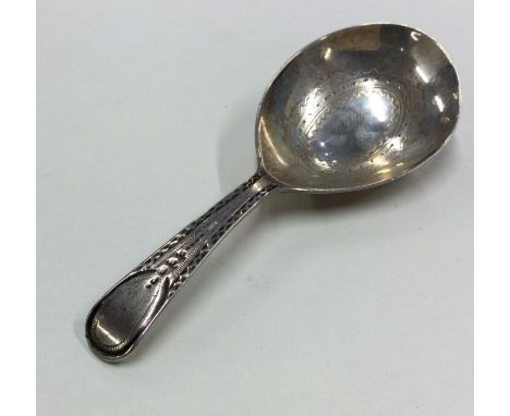 A Georgian silver bright cut caddy spoon with engraved bowl. London. By JW. Approx. 11 grams. Est. £30 - £50.