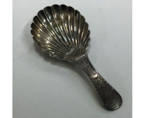 A Georgian silver caddy spoon with bright cut decoration to fluted bowl. Approx. 5 grams. Est. £20 - £30.
