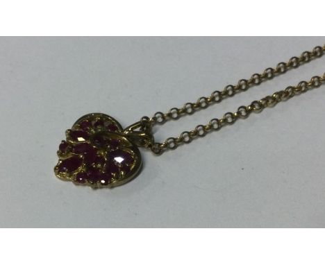 A 9 carat ruby heart shaped pendant with loop top. Approx. 7 grams. Est. £100 - £150.