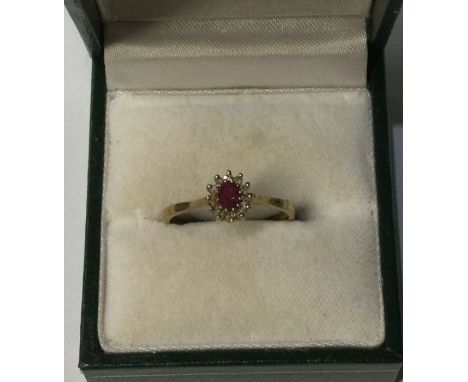 A 9 carat ruby and diamond cluster ring. Approx. 2 grams. Est. £50 - £80.