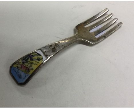 An unusual silver and enamelled 'Jack and Jill' fork of tapering form. Marked 'Sterling'. Approx. 13 grams. Est. £40 - £60.