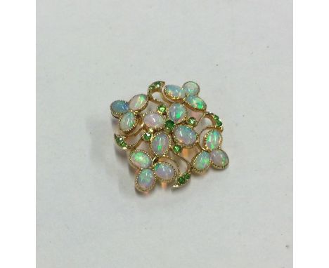 An attractive Victorian opal and demantoid garnet brooch / pendant of shaped form. Approx. 3.2 cms across. Approx. 4 grams. E