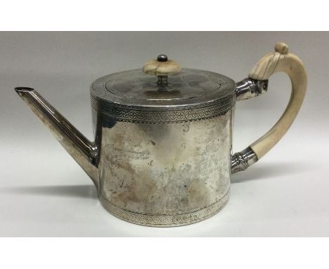 A good Georgian ivory handled drum silver teapot. London 1777. By CA. Approx. 388 grams. Est. £450 - £500.