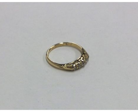 An 18 carat gold five stone diamond ring. Approx. 3 grams. Est. £50 - £80.