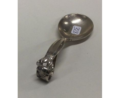 GEORG JENSEN: An unusual silver caddy spoon of typical form. Approx. 25 grams. Est. £80 - £120.