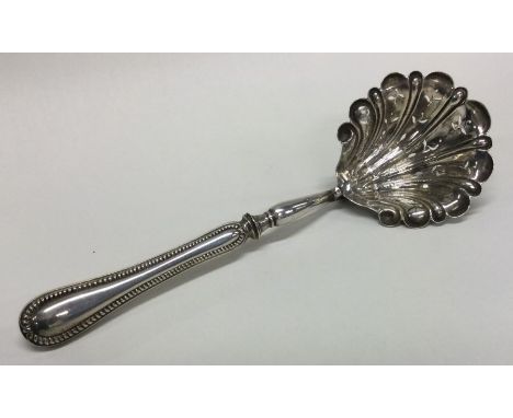 A Continental silver sifter ladle with bead edge. Approx. 54 grams. Est. £30 - £50.