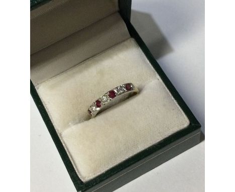 A ruby and diamond seven stone ring in 18 carat gold mount. Approx. 2 grams. Est. £50 - £80.