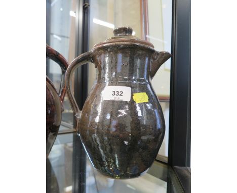 A Trevor Corser lidded jug, with dark green glaze, Leach Pottery and personal stamps, 23 cm high 