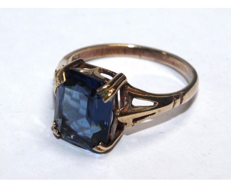 A 9 carat gold ring set with faux sapphire 